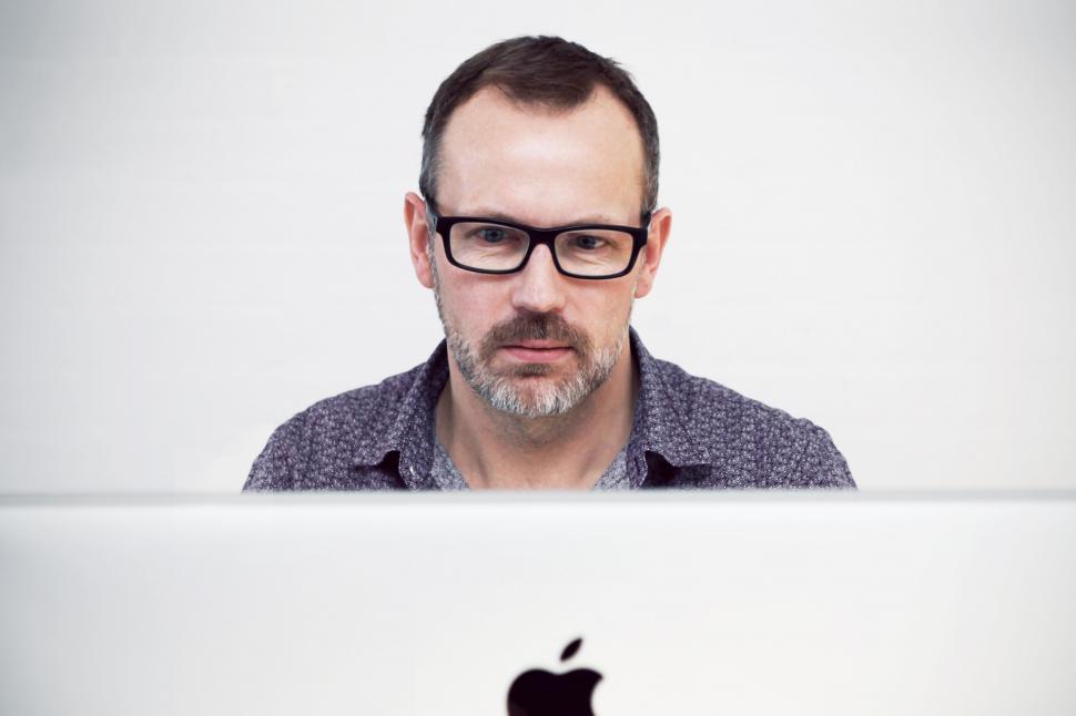 Free Image of Man With Glasses Looking at Laptop 
