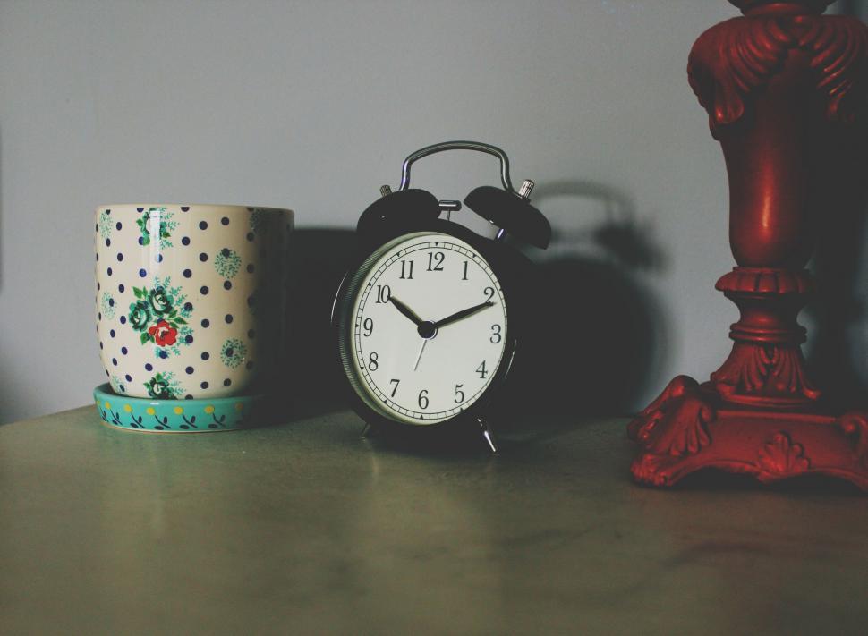Free Image of Clock and Cup on Table 