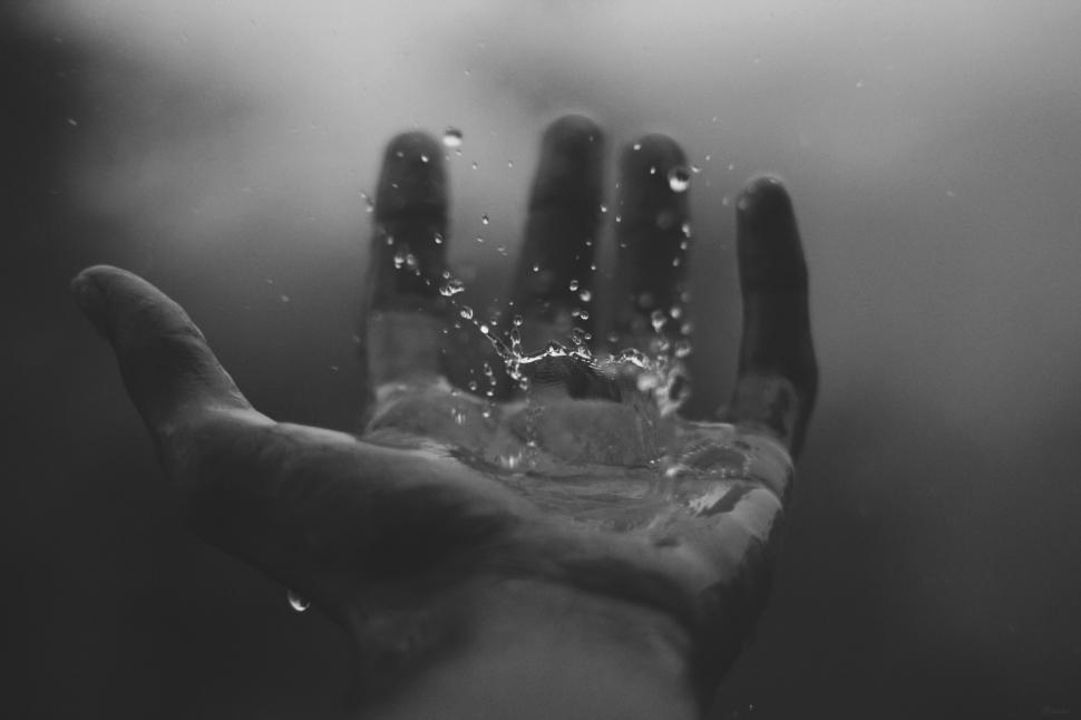 Free Image of Hand With Water Splashing Out 