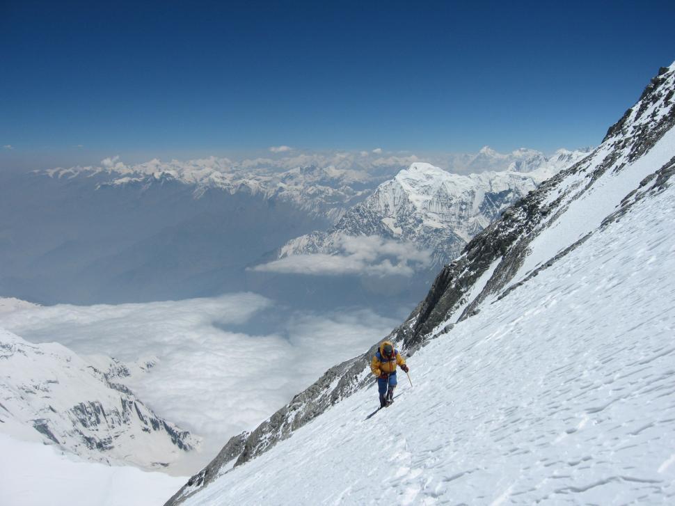 Free Image of Man Climbing Up Snow Covered Mountain 