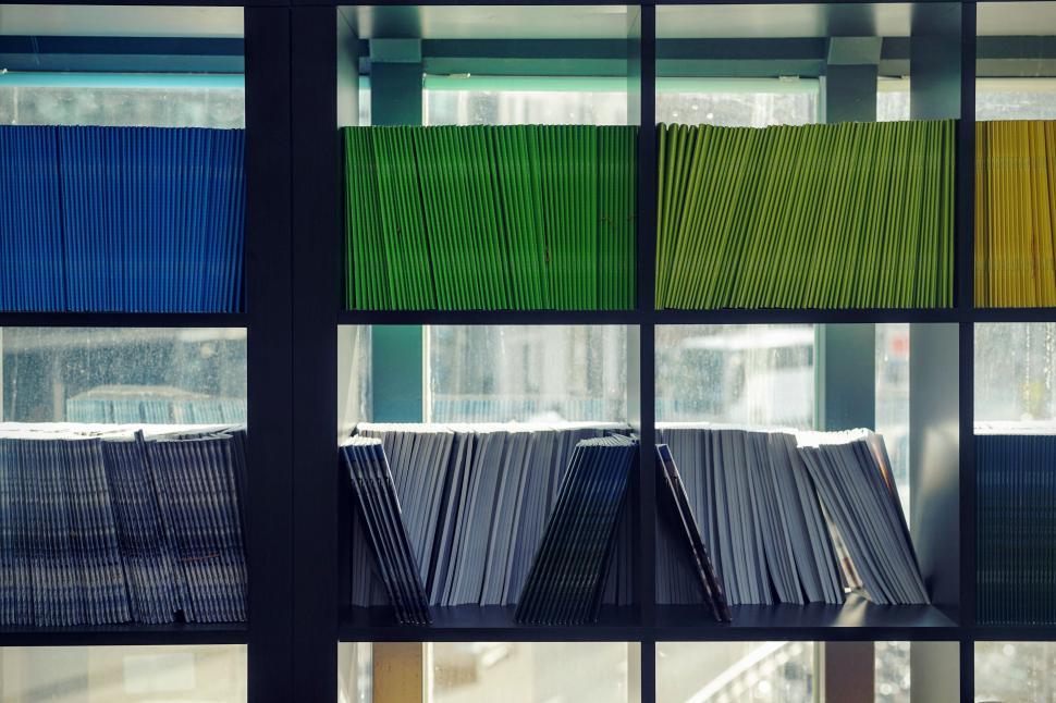 Free Image of Row of Books by Window 