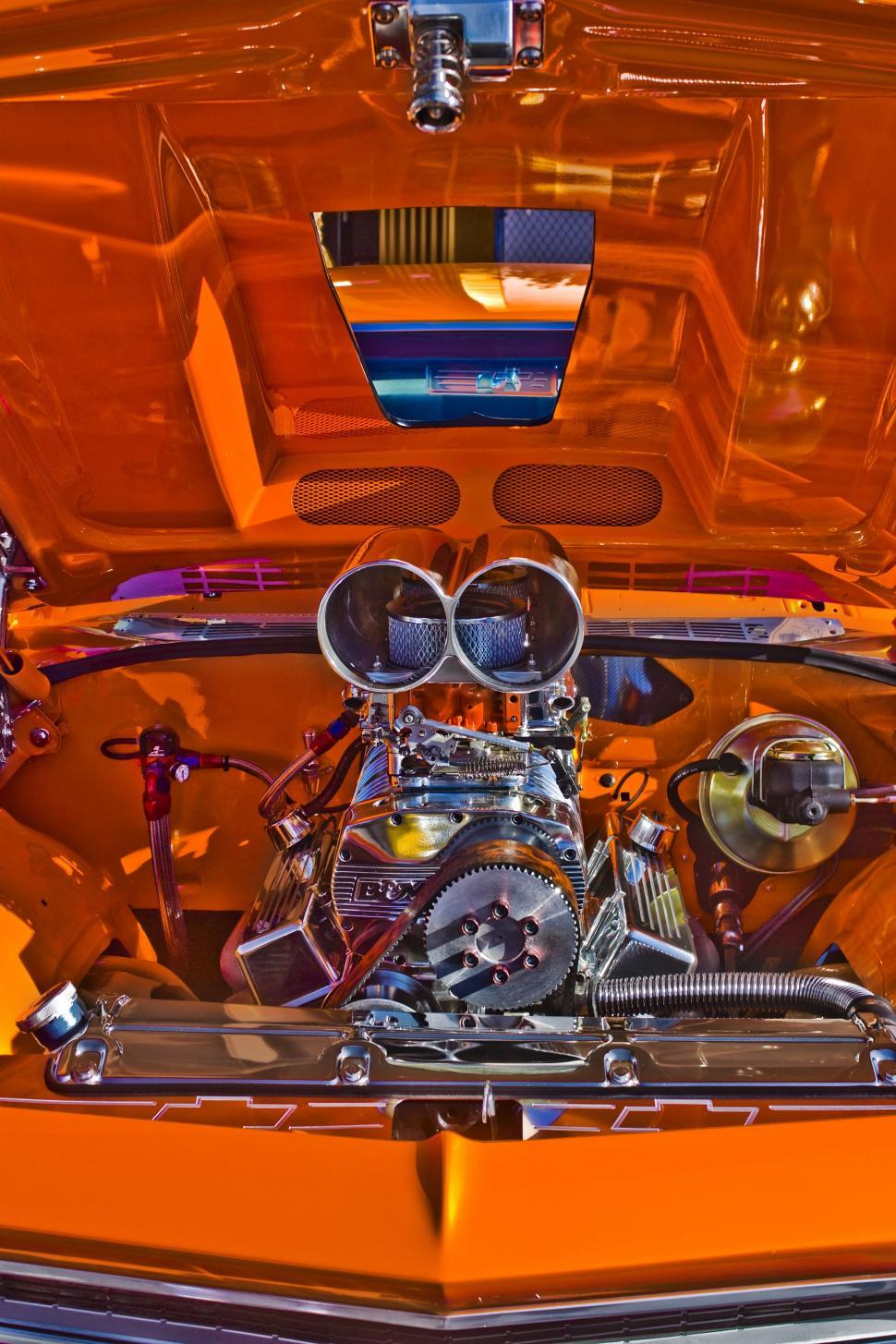 Free Image of Close Up of the Engine of an Orange Car 