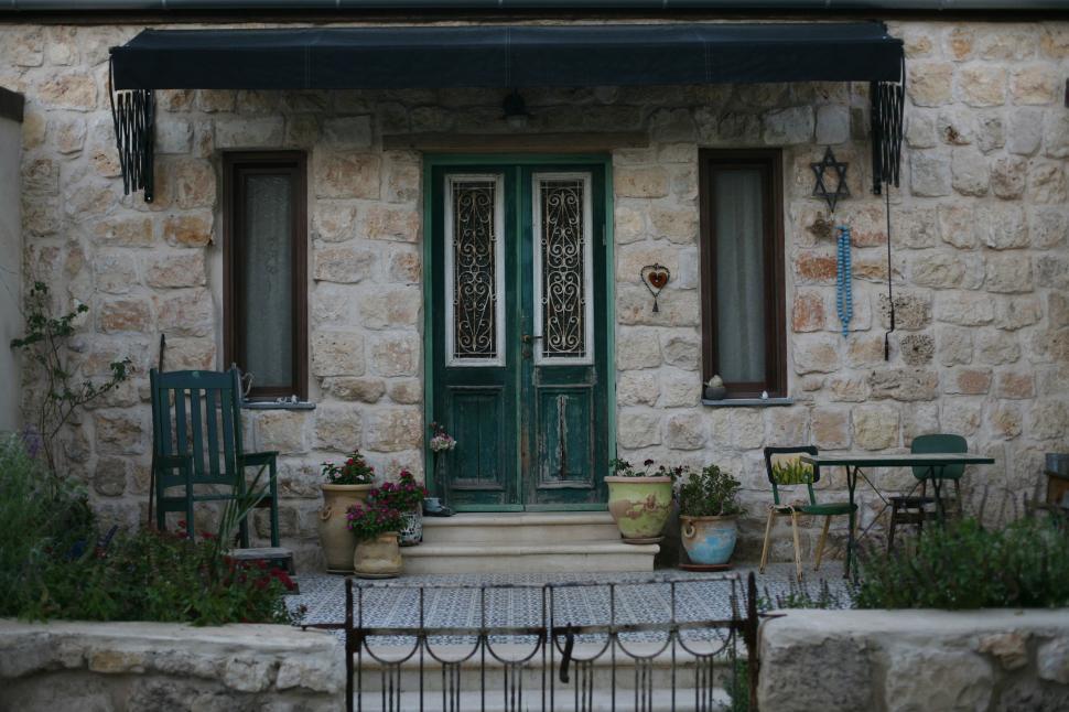 Free Image of Stone House With Green Door and Awning 