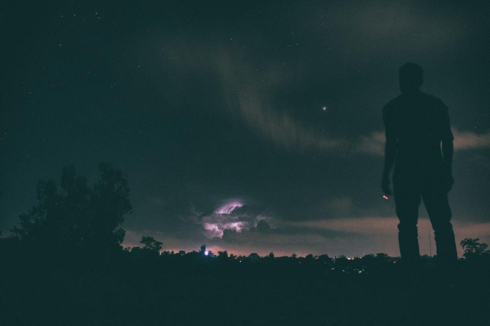 Free Image of Man Standing on Hill at Night 