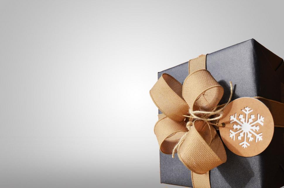 Free Image of Black Box With Brown Bow and Snowflake Tag 