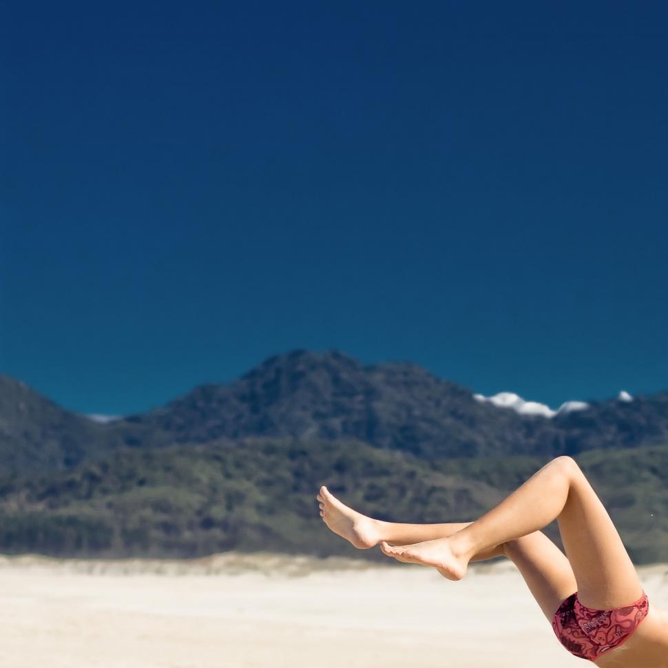 Free Image of Woman in Bikini Laying on Beach 