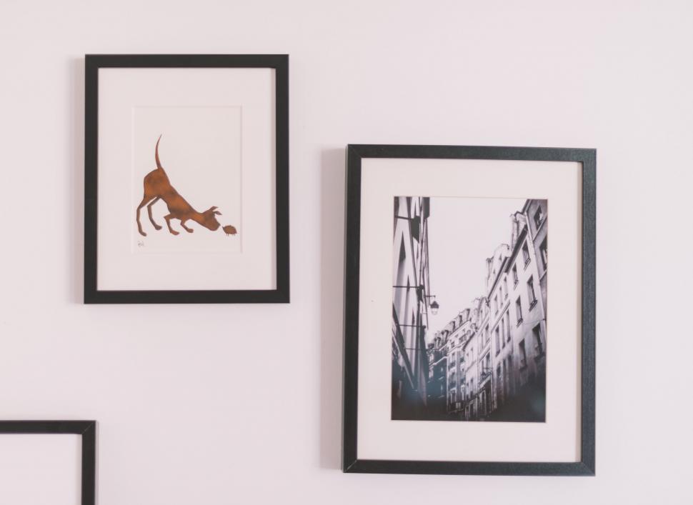 Free Image of White Wall With Three Framed Pictures 