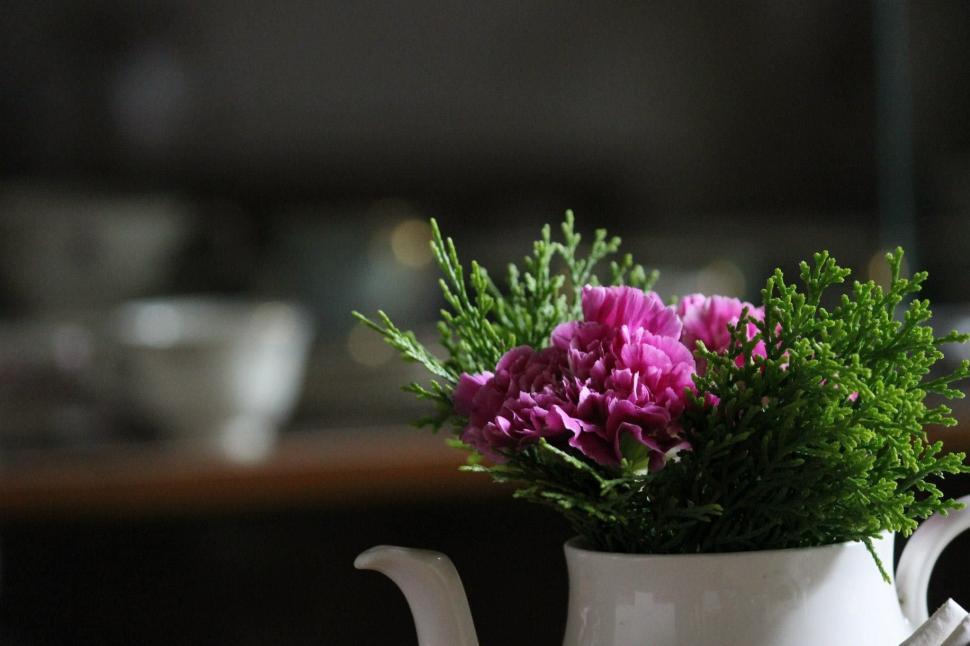 Free Image of White Pitcher Filled With Purple Flowers on Table 