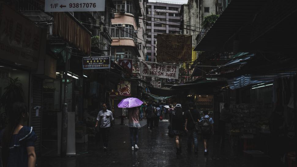 Free Image of Group of People Walking Down Street Holding Umbrellas 