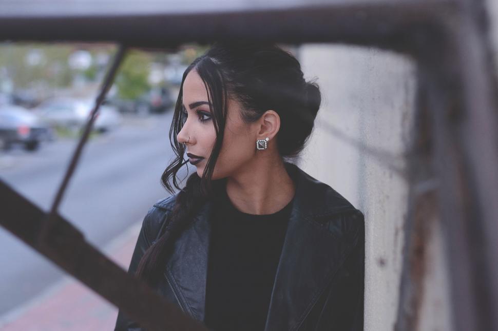 Free Image of Woman in Black Jacket Looking Out Window 
