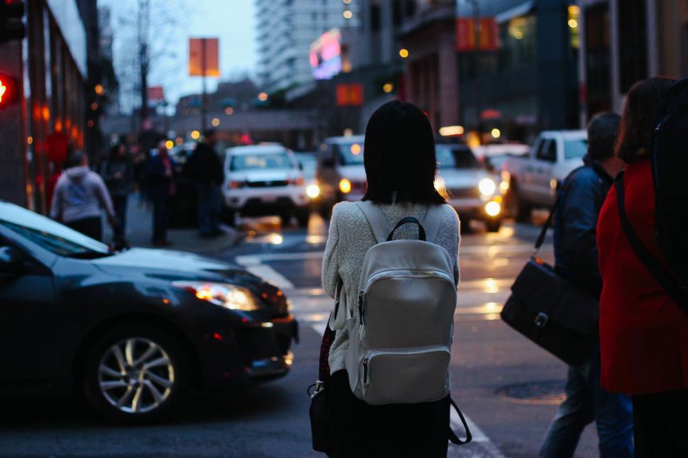 Free Image of Woman Walking Down Street With Backpack 