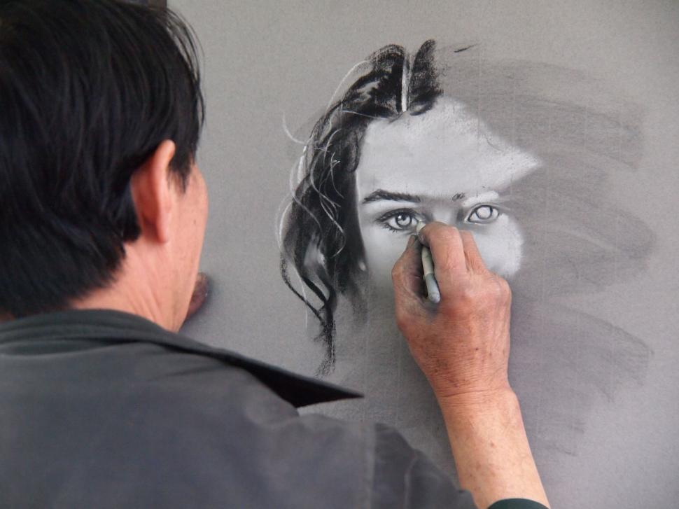 Free Image of Man Drawing Womans Face on Wall 