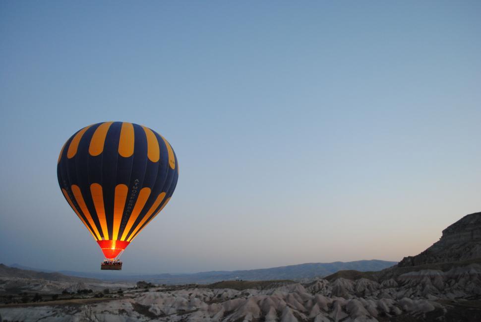 Free Image of Hot Air Balloon Soaring Over Rocky Landscape 