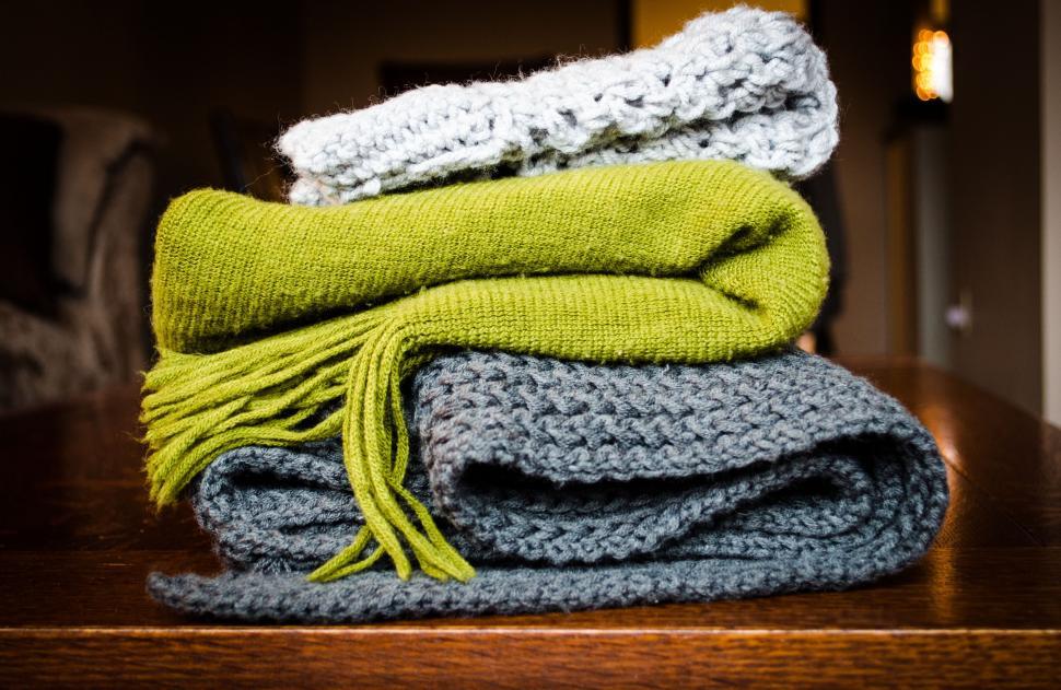 Free Image of Stack of Folded Blankets on Wooden Table 