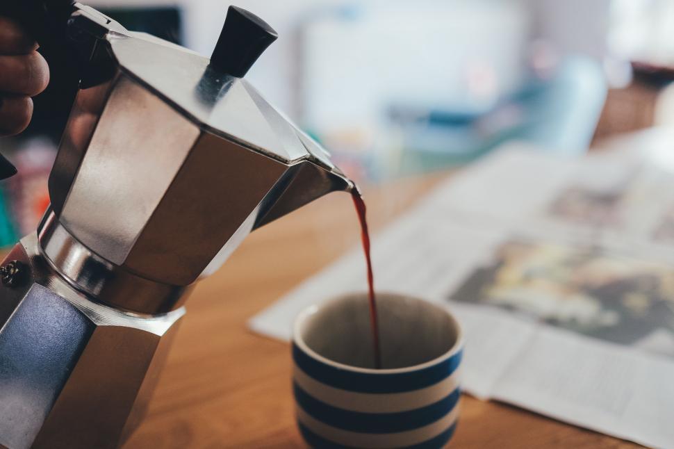 Free Image of Person Pouring Coffee Into Cup 
