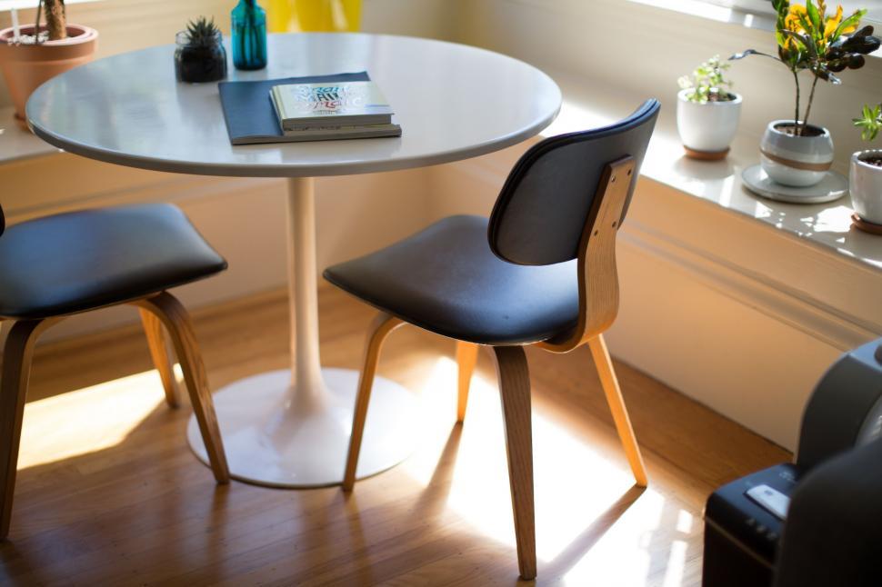 Free Image of Table With Two Chairs and a Book 