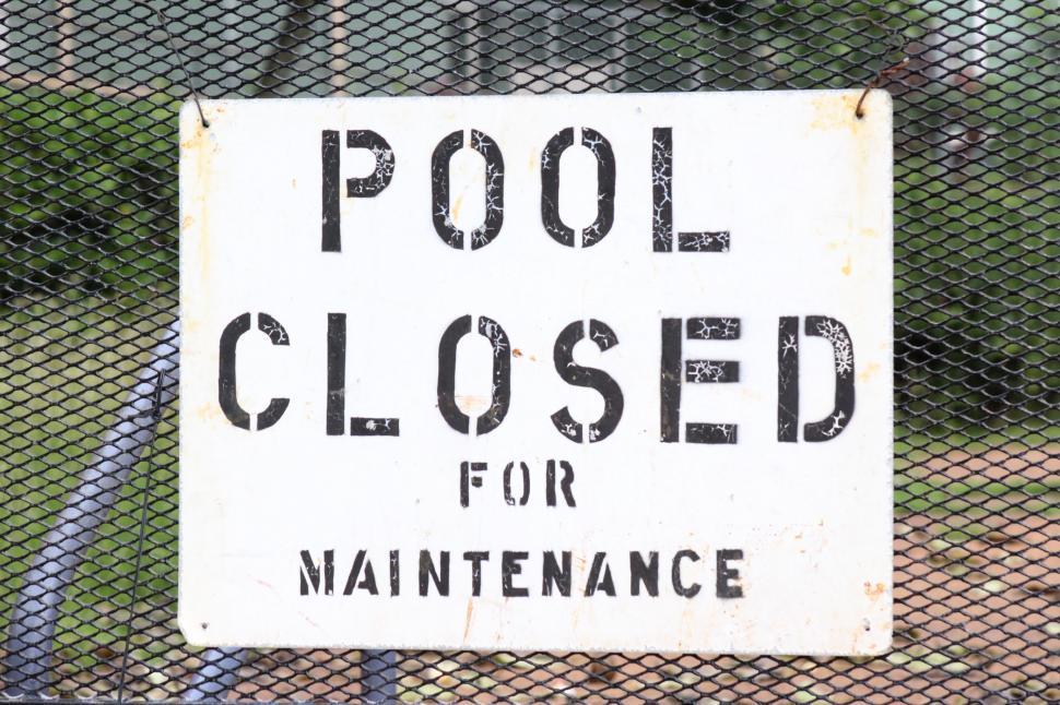 Free Image of Pool Closed for Maintenance Sign on Chain Link Fence 