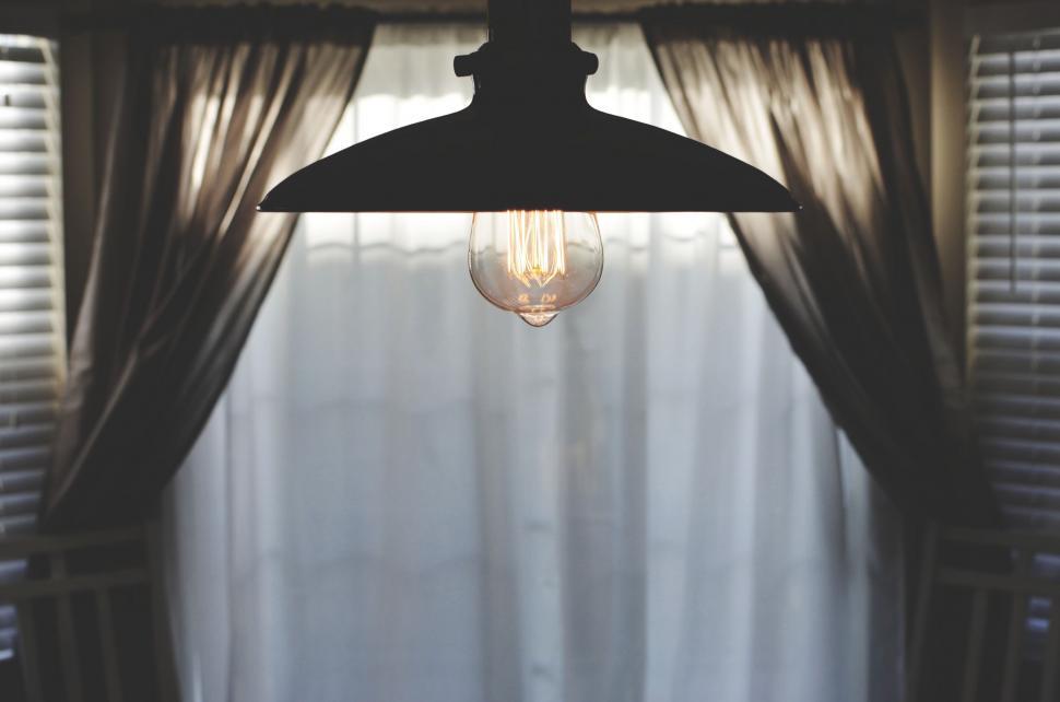 Free Image of Lamp Hanging From Ceiling in Front of Window 