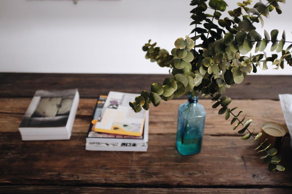 Free Image of Wooden Table With Books and Flower Vase 