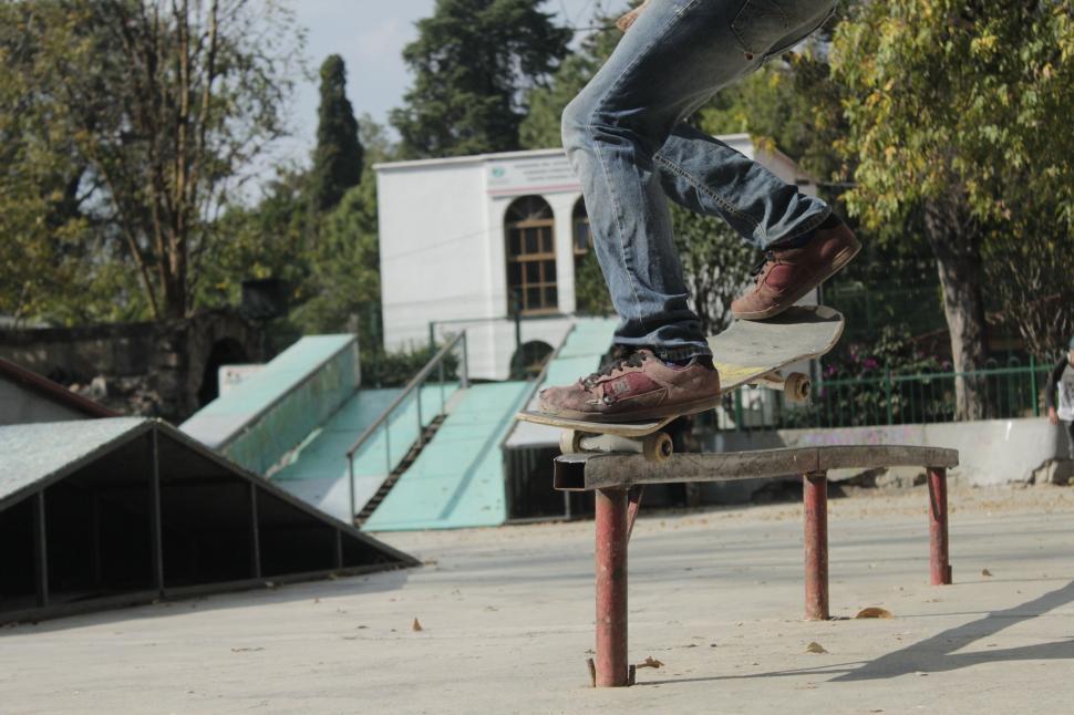 Free Image of Man Riding Skateboard on Top of Metal Rail 