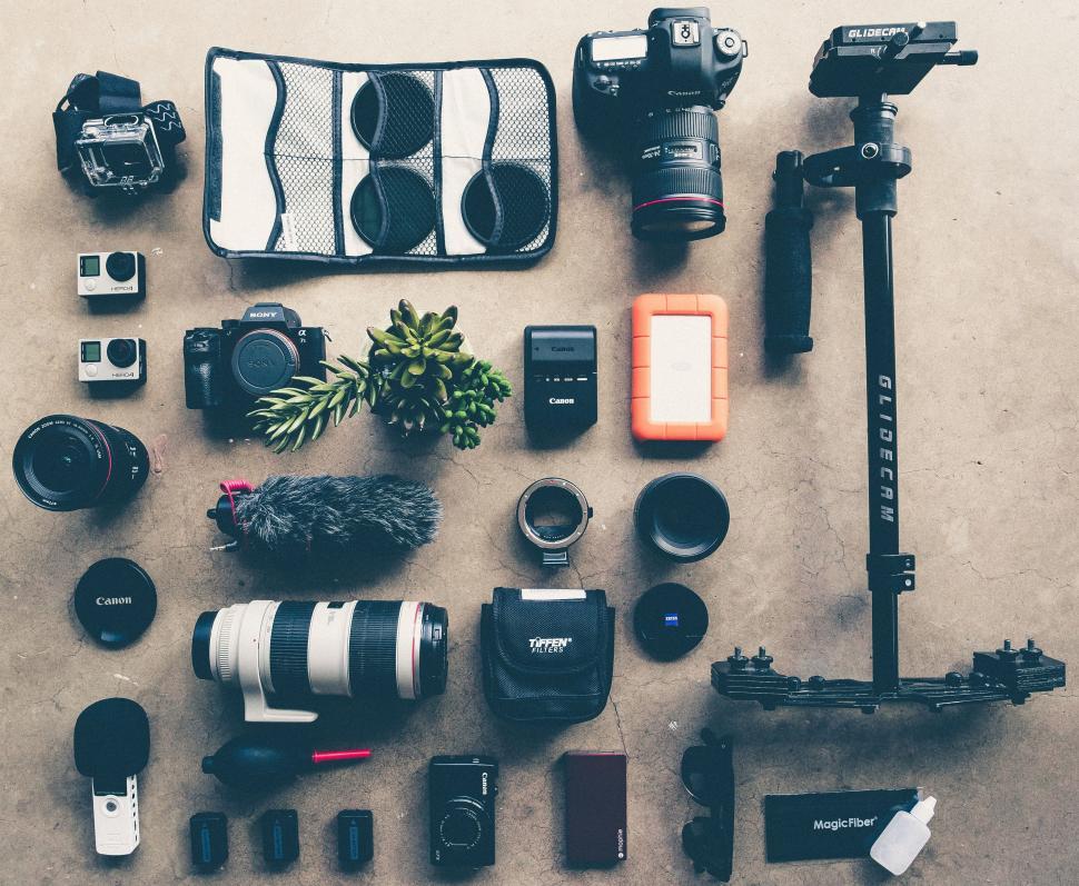 Free Image of A Collection of Cameras and Other Photography Equipment on a Tripod 
