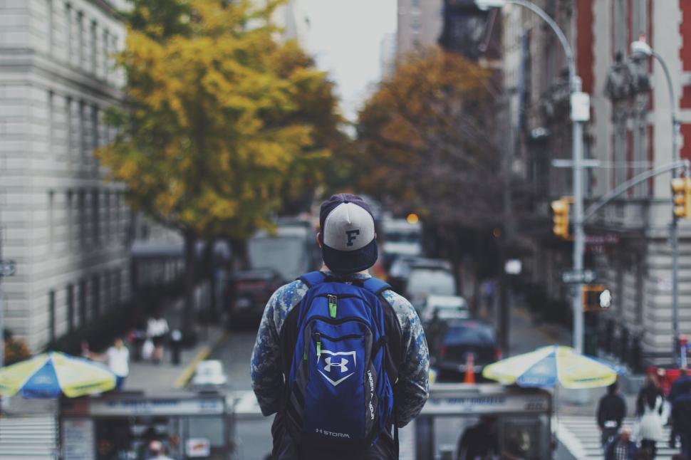 Free Image of Man Walking Down the Street With Backpack 