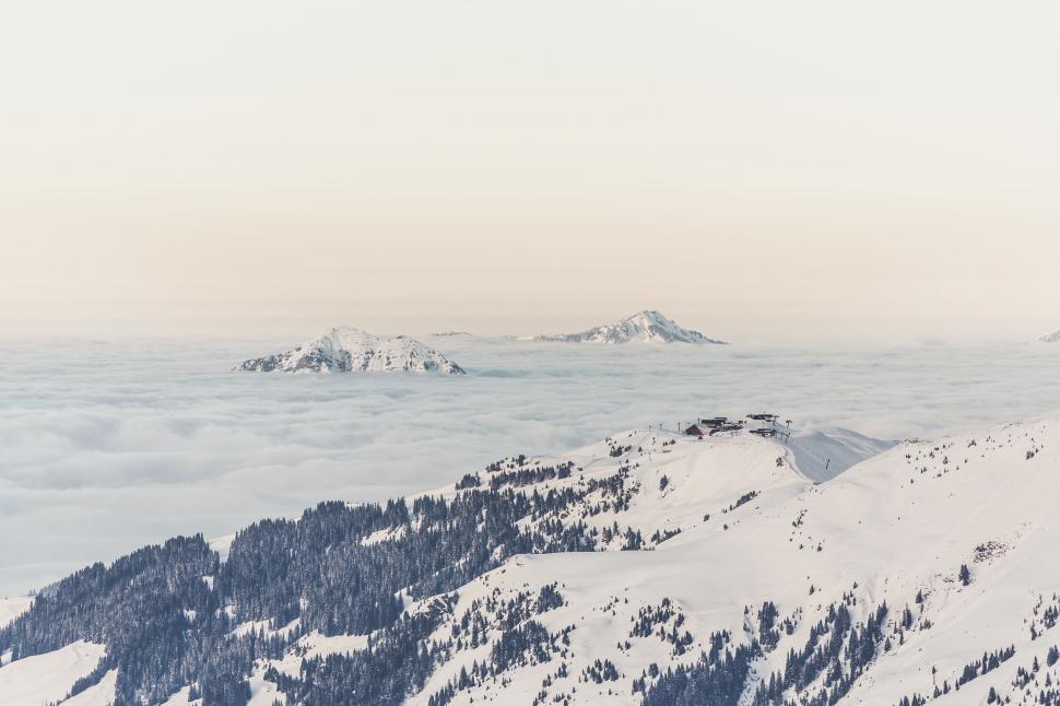 Free Image of Snowboarder Standing on Top of Snowy Mountain 