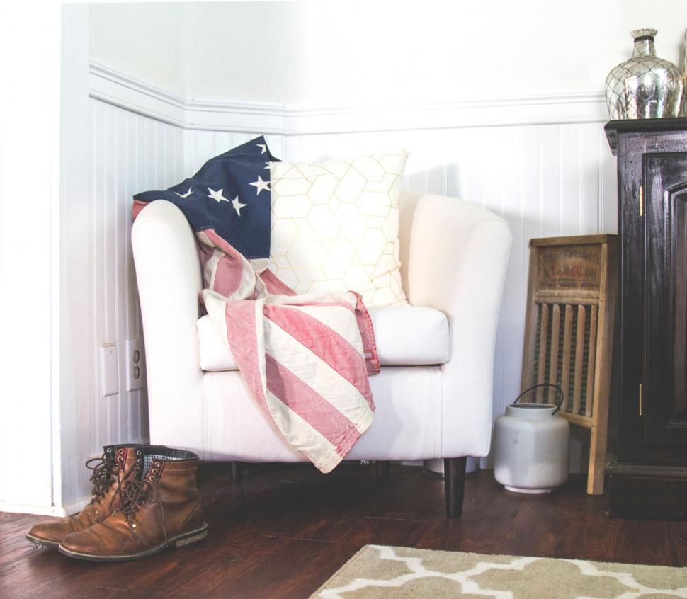 Free Image of White Chair With Red, White, and Blue Blanket in Living Room 
