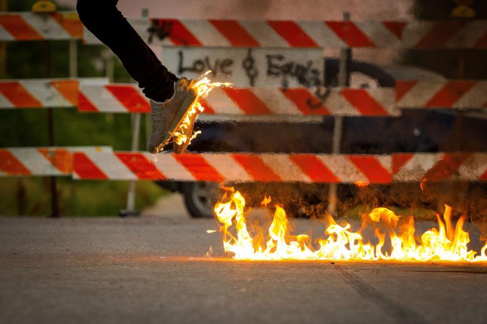 Free Image of Skateboarder Performing Trick Over a Fire 