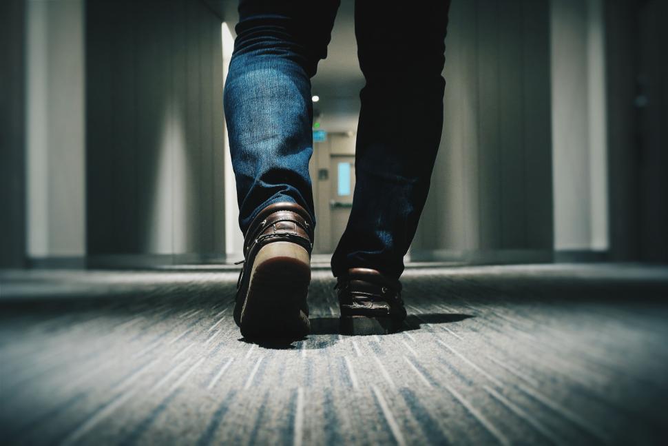 Free Image of Person Walking Down a Hallway in a Building 