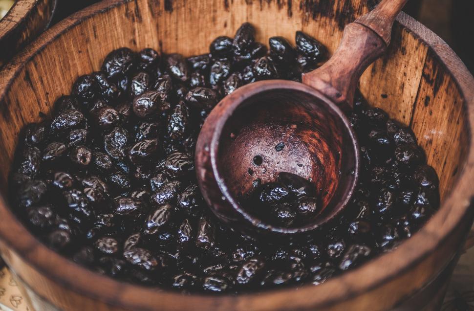 Free Image of Wooden Bowl Filled With Raisins and Wooden Spoon 