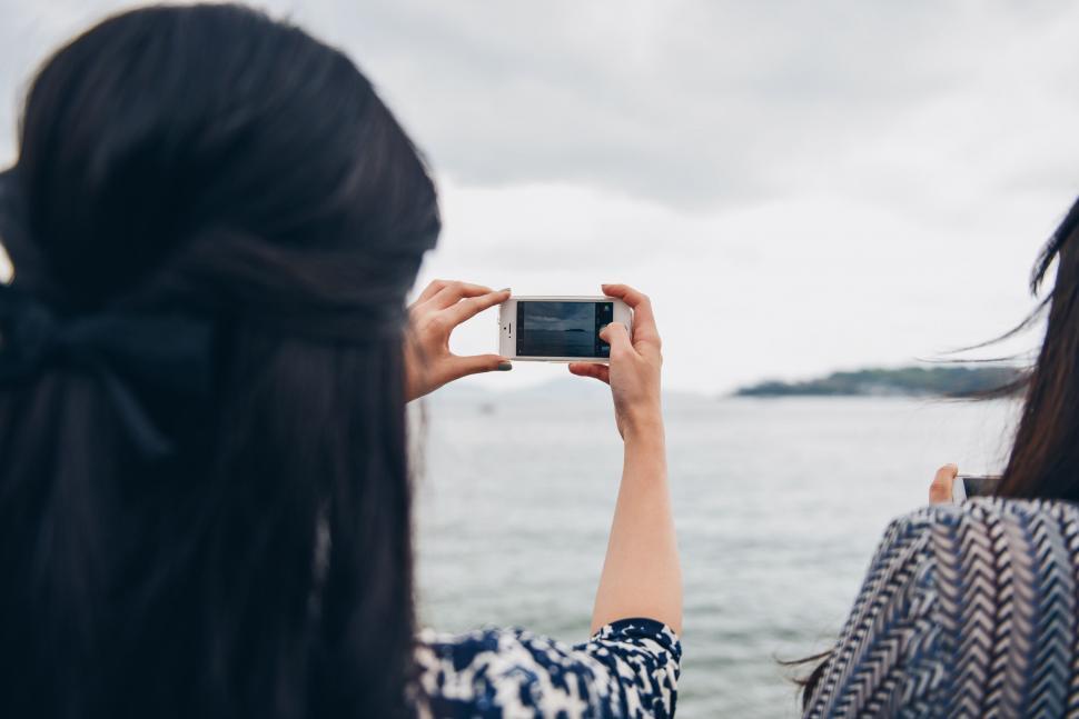 Free Image of Woman Taking a Picture With Her Cell Phone 