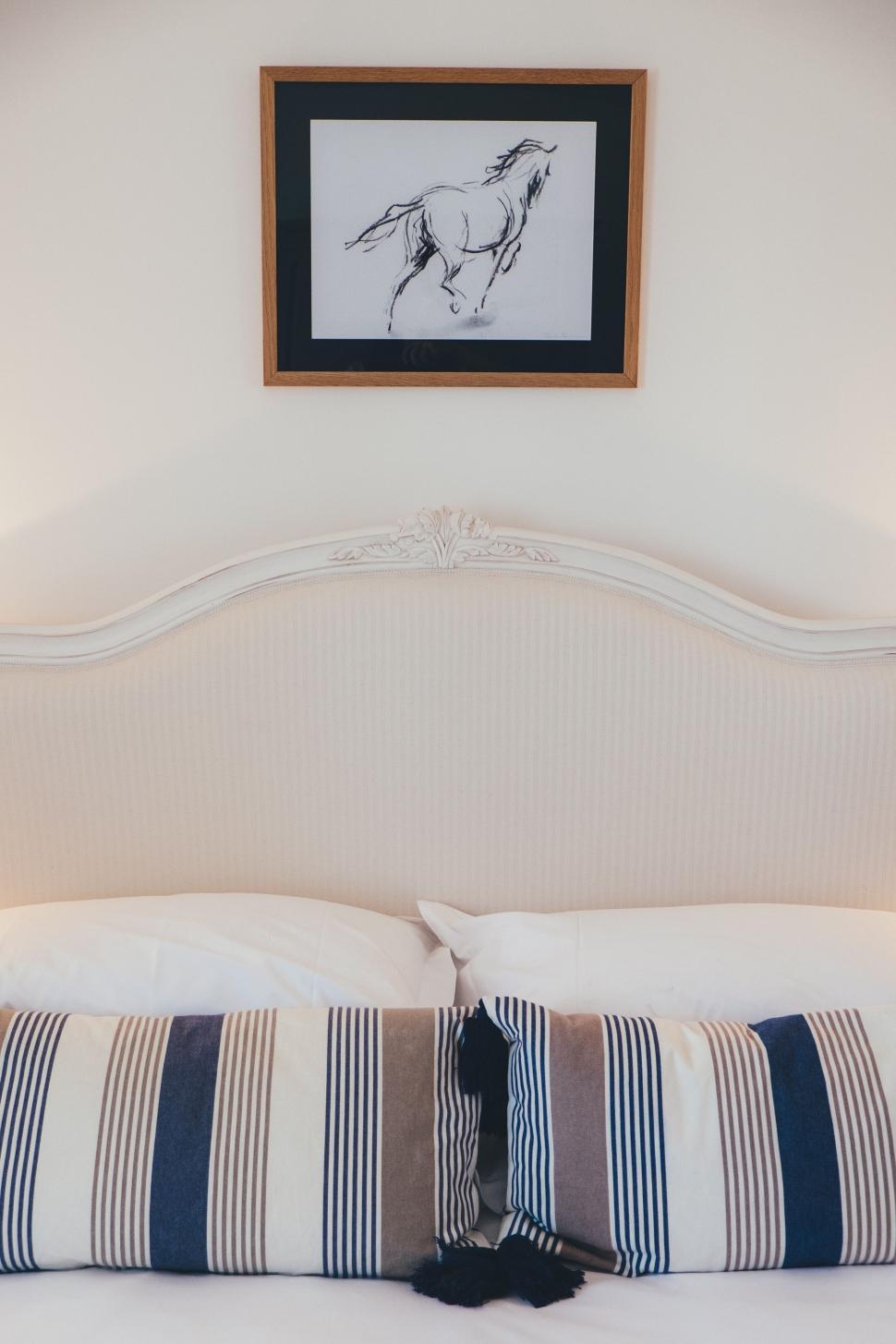 Free Image of Horse Painting Above Bed 