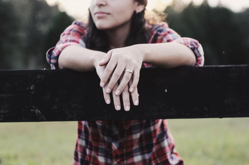 Free Image of Woman Leaning on Fence in Field 