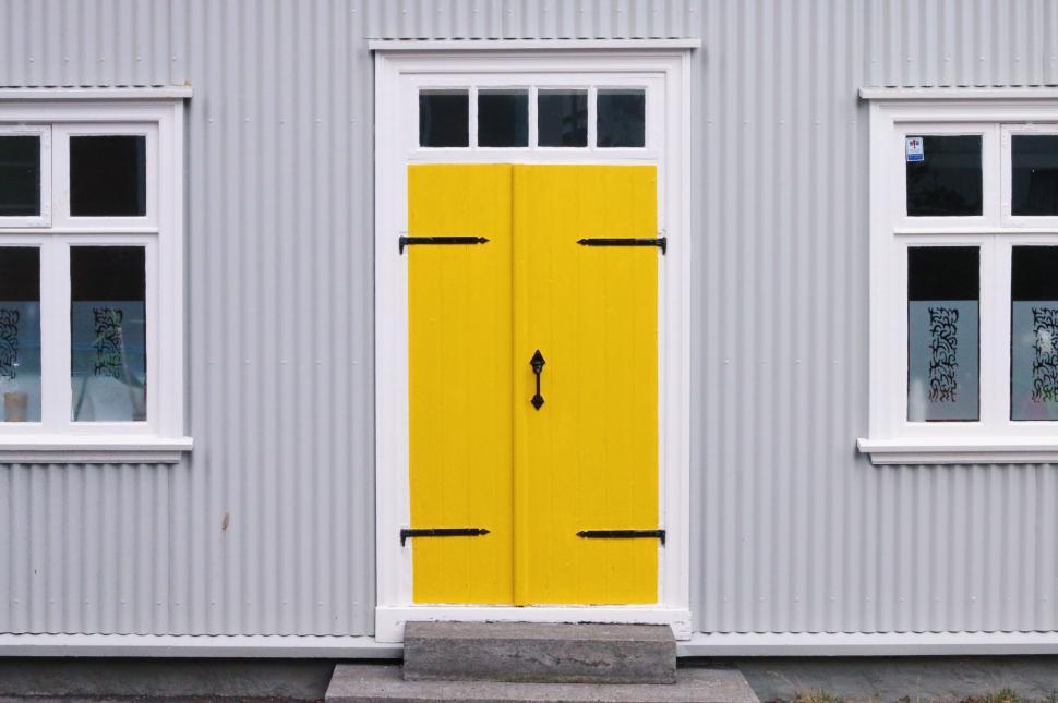 Free Image of Yellow Door in Front of Gray Building 