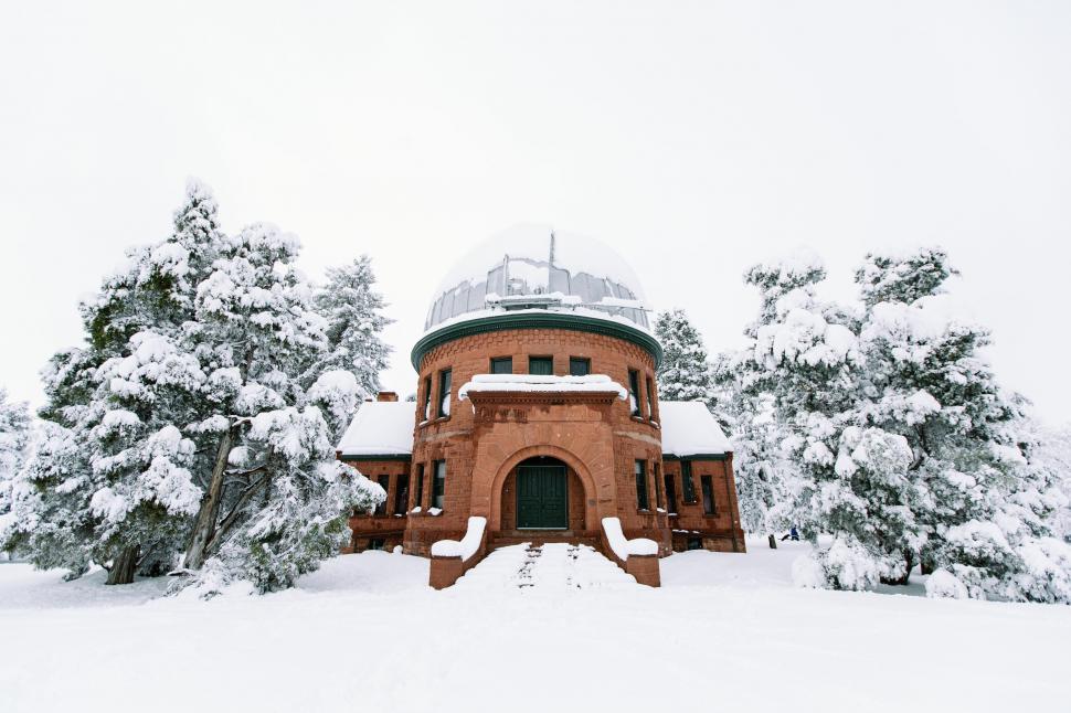 Free Image of Red Building Surrounded by Snow-Covered Trees 