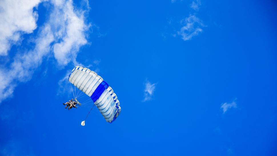 Free Image of Person Parasailing in Blue Sky 
