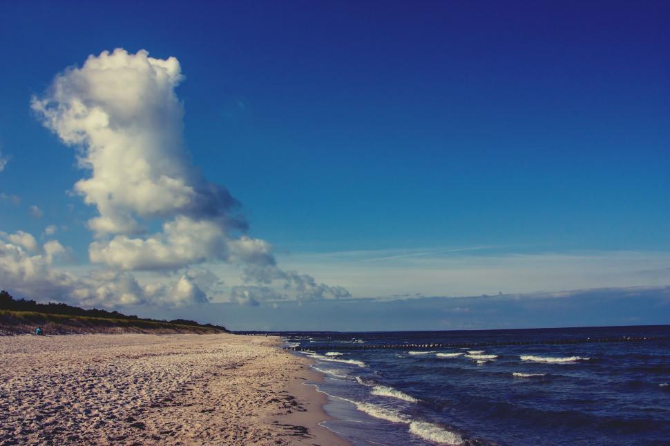 Free Image of Sandy Beach With Waves and Cloud in the Sky 