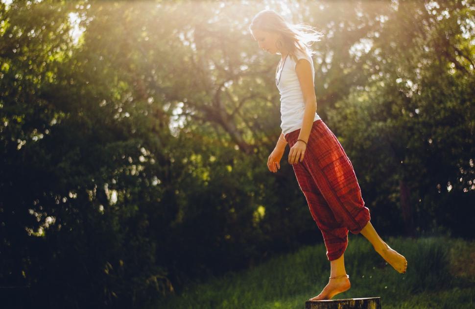 Free Image of Woman Standing on Top of Wooden Block 