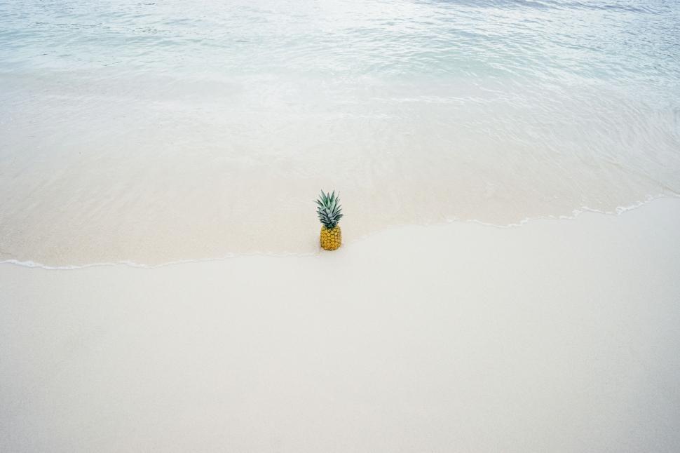 Free Image of Pineapple on White Sand Beach 