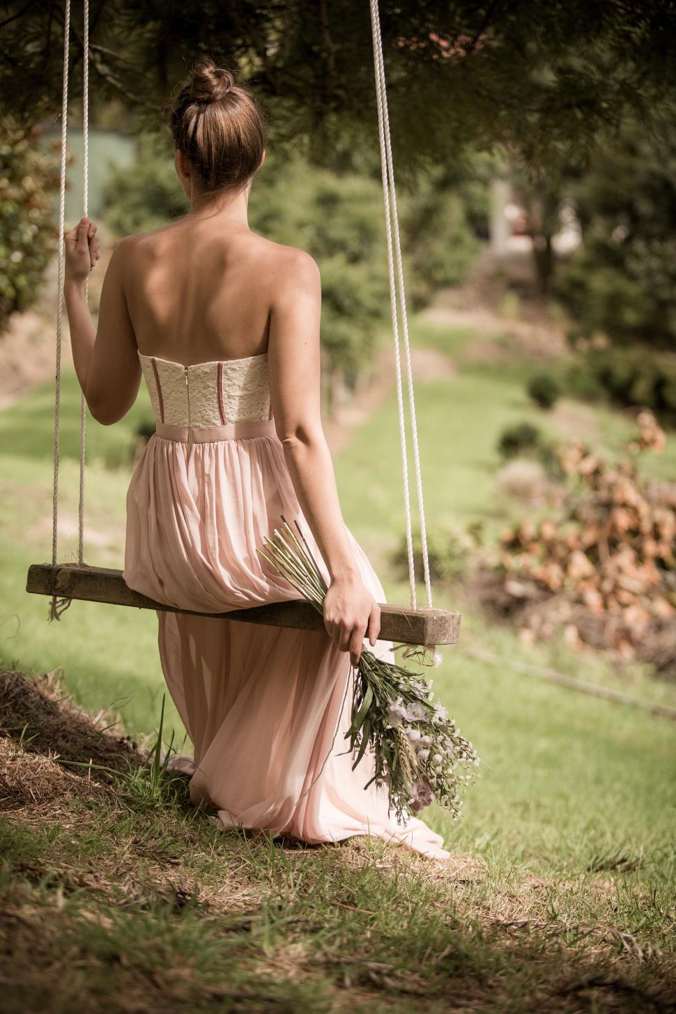 Free Image of Woman in Dress Sitting on Swing 