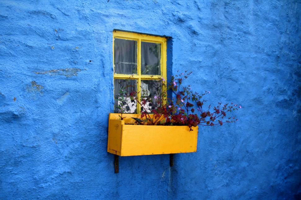 Free Image of Blue Building With Yellow Window and Planter 