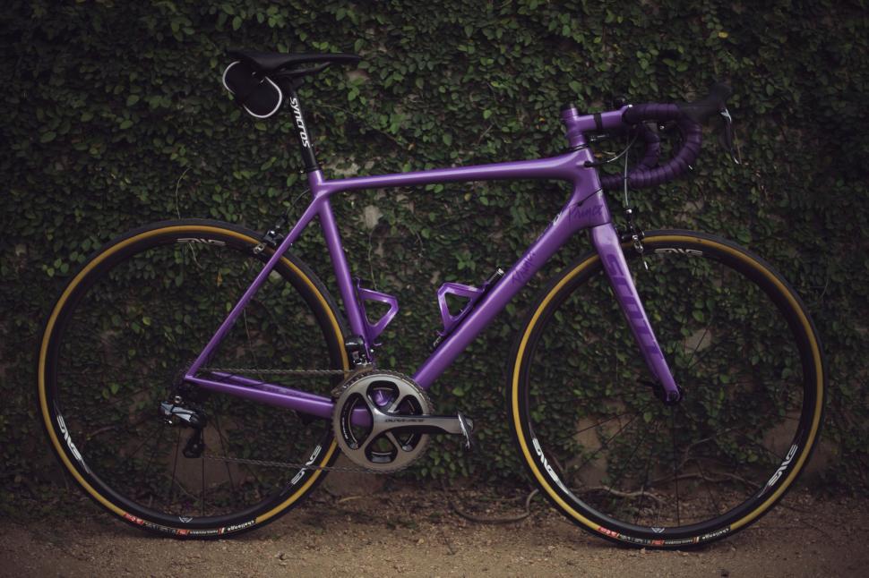 Free Image of Purple Bike Parked in Front of Wall 