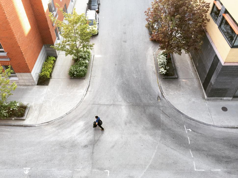 Free Image of Man Skateboarding Down the Middle of a Street 