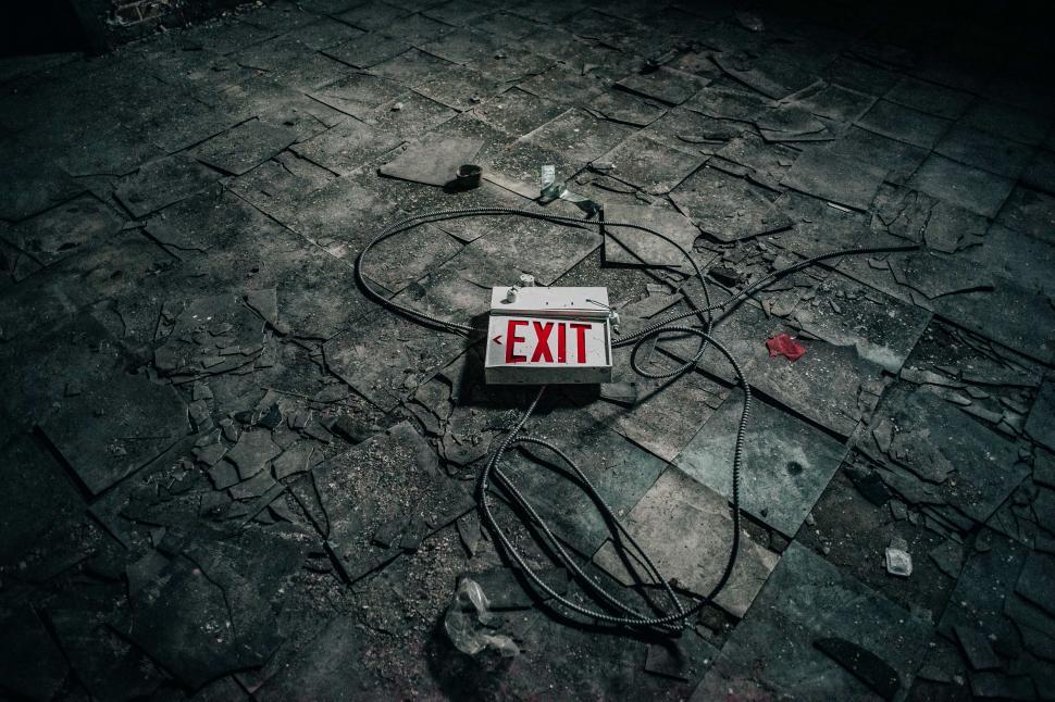 Free Image of Red Exit Sign on Dirty Floor 