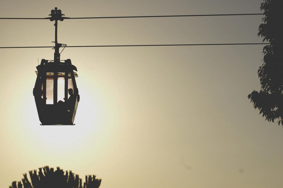 Free Image of Person Riding Ski Lift in the Sky 