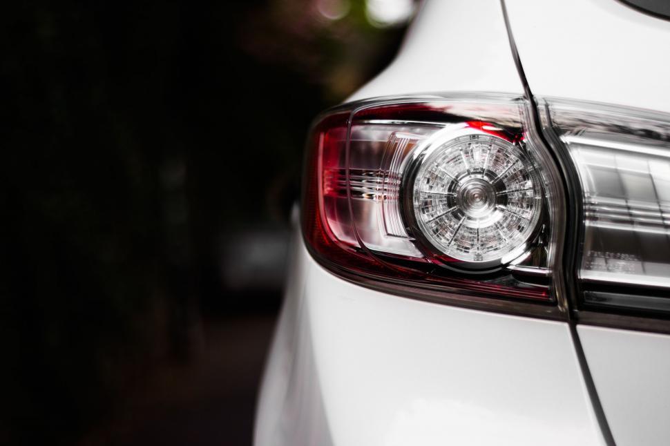 Free Image of Close Up of the Tail Light of a White Car 