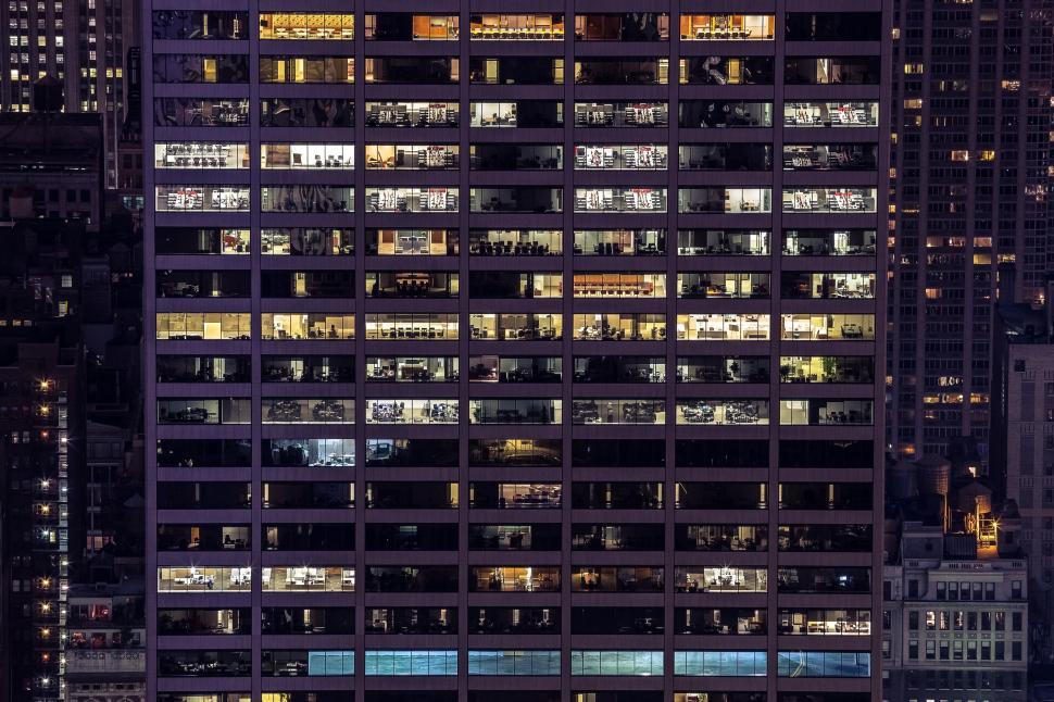Free Image of Tall Building With Many Windows Illuminated at Night 