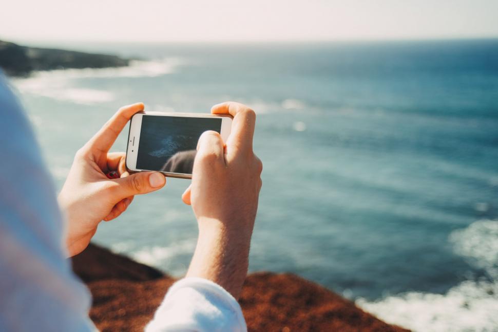 Free Image of Person Taking a Picture of the Ocean With a Cell Phone 