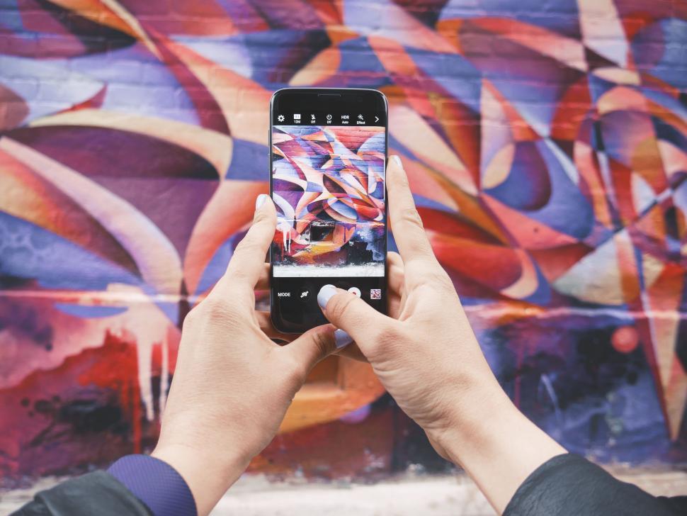 Free Image of Person Capturing Graffiti on Wall 